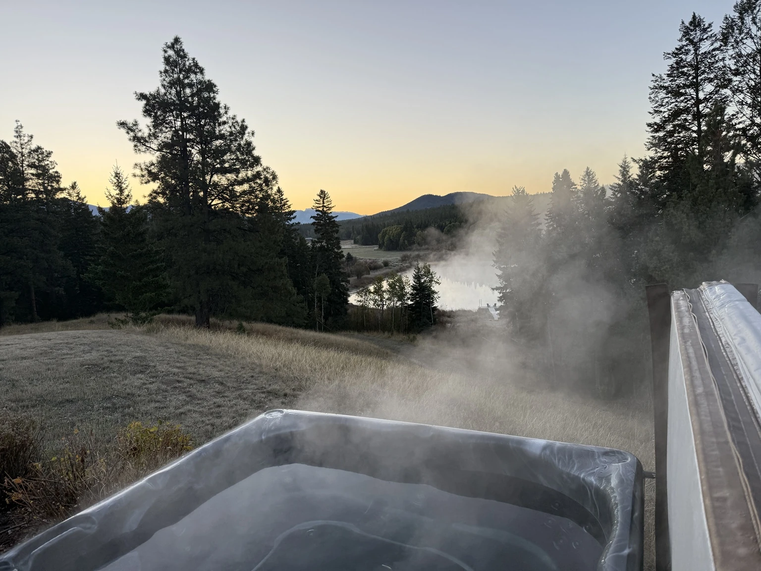 Year-round hot tub with private-lake and mountain views at Pine and Peak