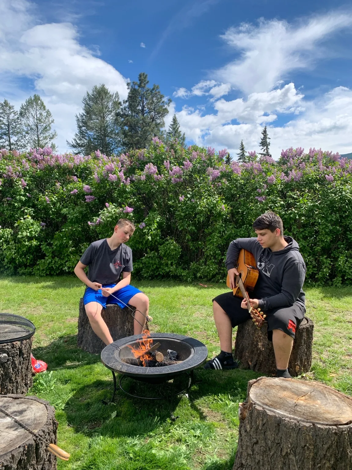 Family enjoying music around the firepit