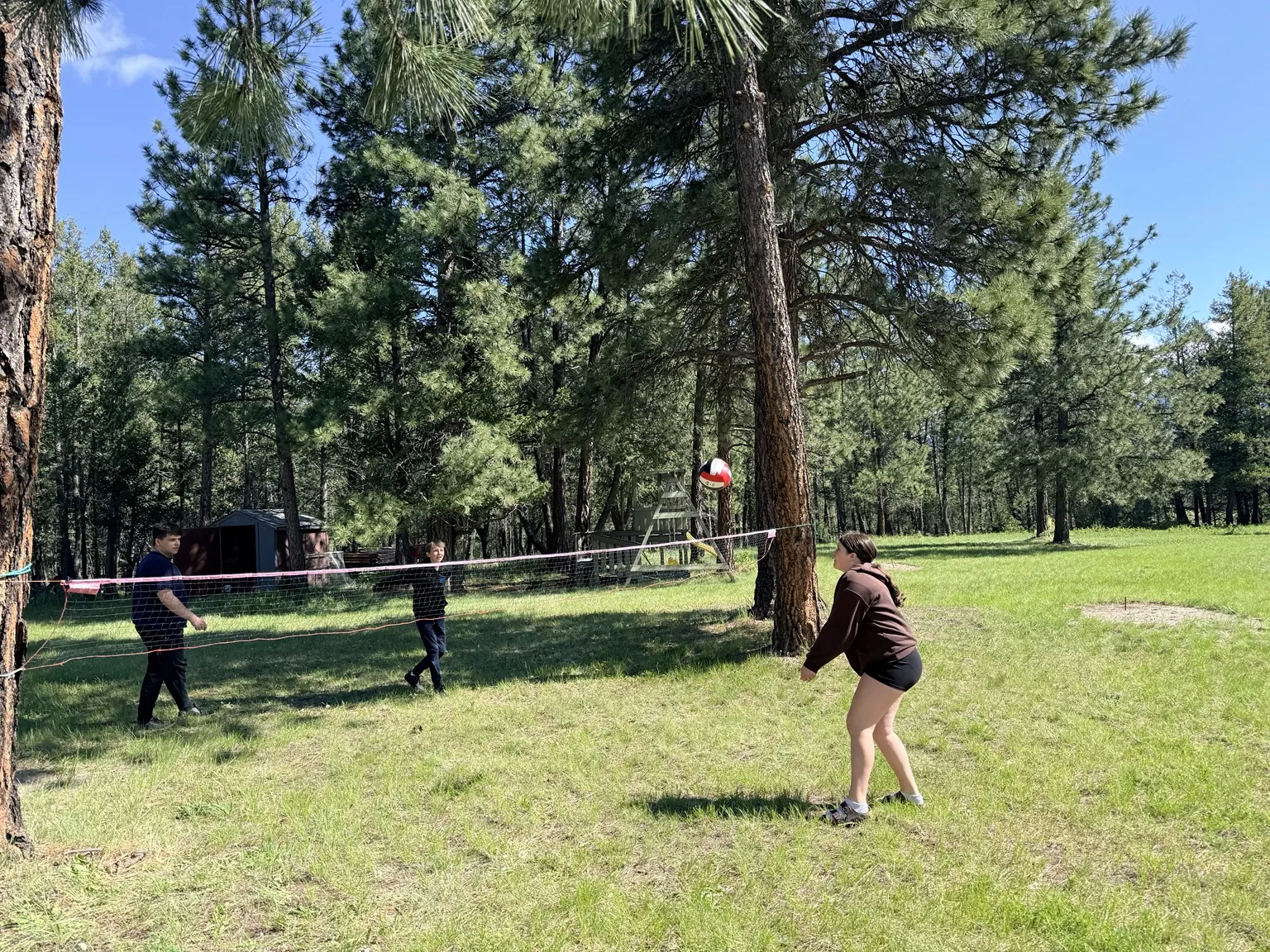 Family playing volleyball outside